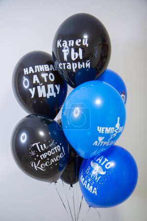 black and blue latex balloons with helium on a white background