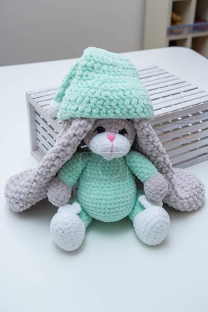 Photo for Plush bunny in a wooden box with long ears, soft toy - Royalty Free Image
