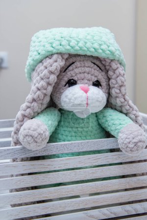 Photo for Plush bunny in a wooden box with long ears, soft toy - Royalty Free Image