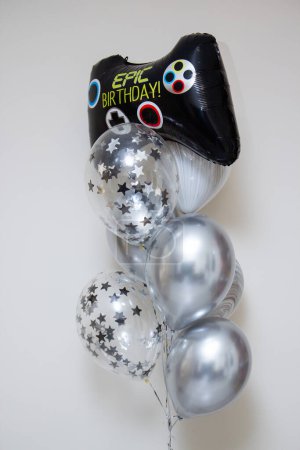 set of silver balloons with confetti on a white background