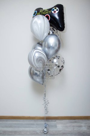 set of silver balloons with confetti on a white background