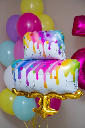 a bunch of bright balloons, a cake-shaped balloon