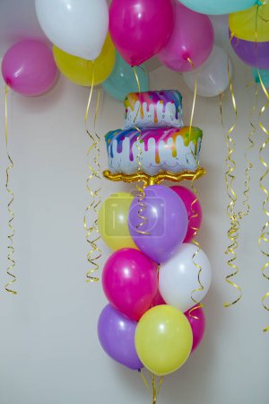 a bunch of bright balloons, a cake-shaped balloon