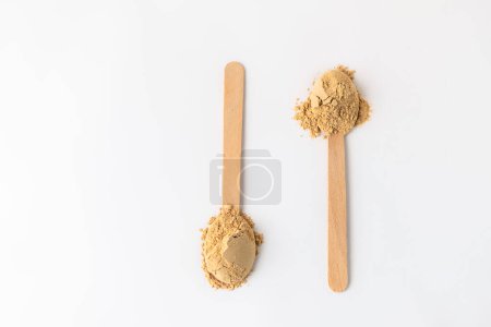 Photo for Top view of two spoons with maca root powder on white background, copy space - Royalty Free Image