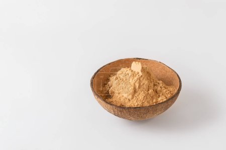 Photo for Organic root powder in a bowl on white background with copy space - Royalty Free Image
