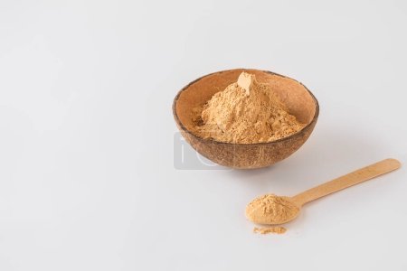 Photo for Bowl of maca root powder with spoon on white background with copy space - Royalty Free Image