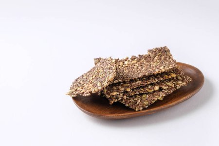 healthy seed crackers on white background with copy space
