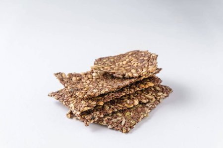 healthy seed crackers on white background with copy space