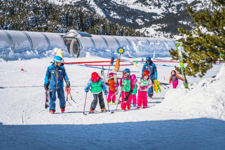 Photo for El Tarter, Andorra, Jan 2020 Ski instructors teaching a group of young kids how to ski. Winter holidays in Pyrenees Mountains - Royalty Free Image