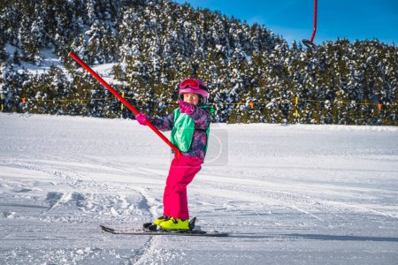 Photo for Young skier, a child, having fun when riding up on a ski drag lift. Winter holidays in El Tarter, Andorra, Pyrenees Mountains, Grandvalira - Royalty Free Image