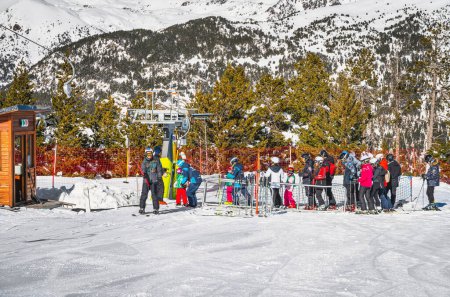 Photo for El Tarter, Andorra, Jan 2020 Ski instructor teaching a group of young kids how to ski and get on ski drag lift. Winter holidays in Pyrenees Mountains - Royalty Free Image