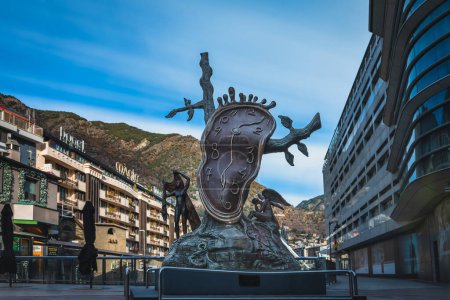 Photo for Andorra la Vella, Jan 2020 Noblesa del temps, Nobility of time, sculpture by Salvador Dali, melting clock and angels. Long exposure, stretched clouds - Royalty Free Image