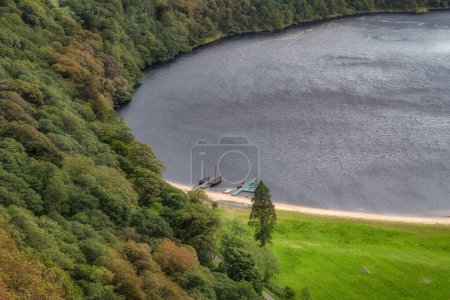 Photo for Beautifull three Viking longships moored at a dock on a Lough Tay, called Guiness Lake in Wicklow Mountains, Ireland - Royalty Free Image