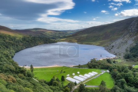 Photo for Aeril view on Lough Tay, called Guiness Lake with a TV show or movie set related to Viking era with longships and village, Wicklow Mountains, Ireland - Royalty Free Image