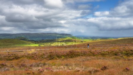 Photo for Woman standing on boardwalk and taking picture, photographing beautiful Cuilcagh Mountain, County Fermanagh, Northern Ireland - Royalty Free Image