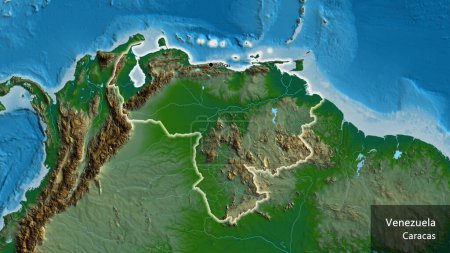 Foto de Primer plano de la zona fronteriza de Venezuela en un mapa físico. Punto capital. Brillan alrededor de la forma del país. Nombre inglés del país y su capital - Imagen libre de derechos