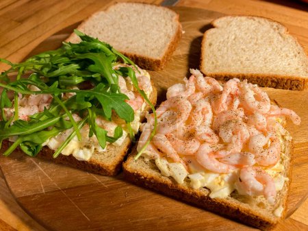 Photo for Sandwiches with shrimp, egg and arugula salad on wooden background. High quality photo - Royalty Free Image