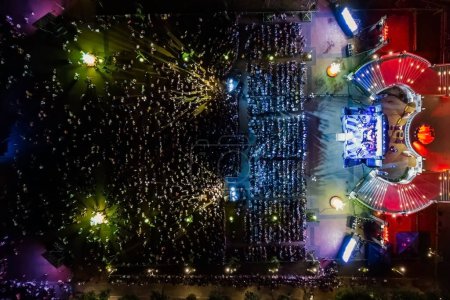 People at night open air concert aerial view.
