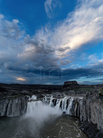 Snake River waterfall with dramatic clouds sundown