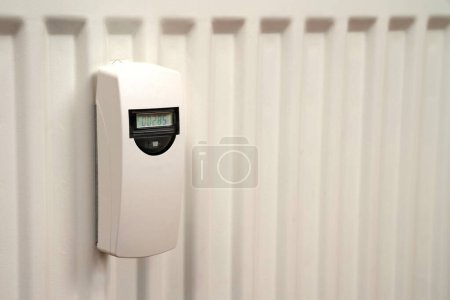 Photo for Heat consumption meter on the white radiator. Close up. - Royalty Free Image