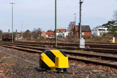 Yellow-black painted railway switch system. Close up.