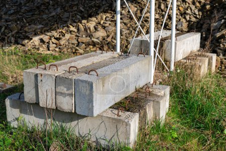 Concrete blocks holding the foundation of a metal mast. Close up.