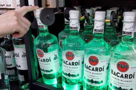 Photo for Bacardi rum for sale at a hypermarket. Buyer Hand holding Bacardi white rum. Ukraine, Kharkiv - May 27, 2023 - Royalty Free Image