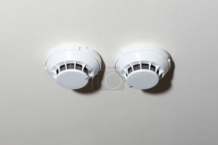 Photo for White ceiling-mounted smoke detectors for fire safety and protection. Essential security equipment - Royalty Free Image