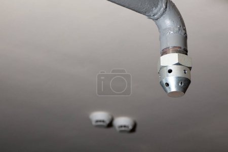 Photo for Gas extinguishing pipeline nozzle and smoke detector for fire suppression. Safety equipment for fire control - Royalty Free Image