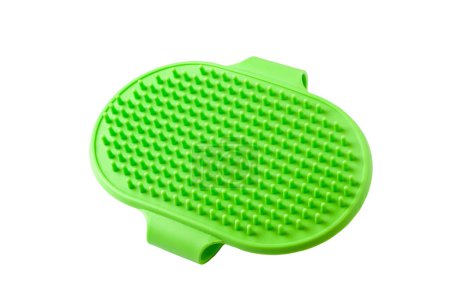 Green silicone grooming brush with soft bristles on a white background