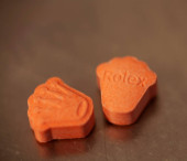 Orange pills with mdma ecstasy dope rolex drug close up background fine art in high quality prints tote bag #632642304