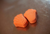 Orange pills with mdma ecstasy dope rolex drug close up background fine art in high quality prints Poster #632642312