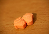 Orange pills with mdma ecstasy dope rolex drug close up background fine art in high quality prints Stickers #632642314
