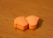 Orange pills with mdma ecstasy dope rolex drug close up background fine art in high quality prints t-shirt #632642318