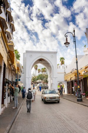 Photo for Tangier, Morocco. October 16th, 2022 - Bab Al Fahs Gate from inside the medina and some shops on Italia Street, with the great souk in the background - Royalty Free Image