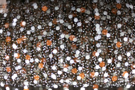 white and orange sparkle glitter on dark background and copy space for your design 