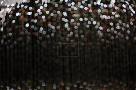 white and orange sparkle glitter on dark background and copy space for your design 