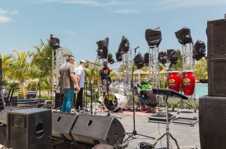Photo for Las Brujas,Cayo Santa,maria,Cuba, Jul.15,2023, technicians, musicians preparing the outdoor concert stage for live music band in the swimming pool area - Royalty Free Image