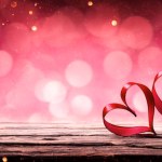 Two Ribbon Hearts On Rustic Wooden Table With Glowing Bokeh Background - Valentines Day 