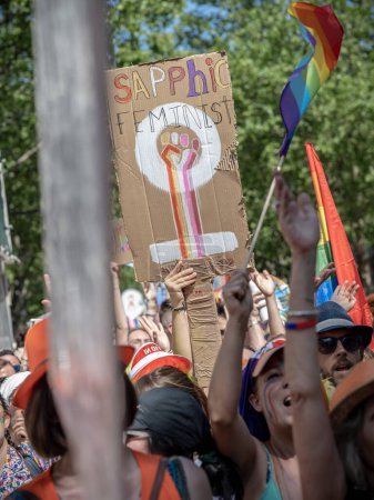 Photo for Paris, France - June 24, 2023: A poster in English at the 2023 Paris gay pride lifted above a crowd on which in is written 'sapphic feminist' - Royalty Free Image