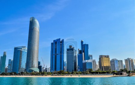 Abu Dhabi city skyline along Corniche beach taken from a boat in UAE