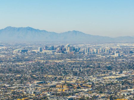 Photo for Phoenix downtown modern city skyline aerial view with Estrella Mountain at back, from the top of Camelback Mountain in city of Phoenix, Arizona AZ, USA. - Royalty Free Image