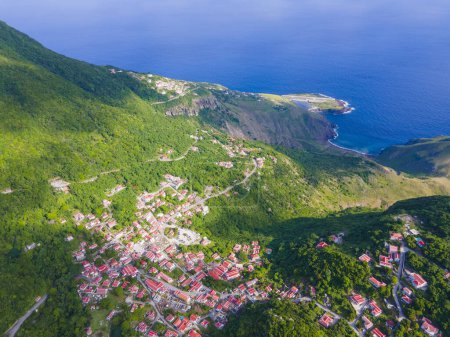 Photo for Windwardside historic town center aerial view, with Saba Juancho E. Yrausquin Airport SAB at the background in Saba, Caribbean Netherlands. - Royalty Free Image