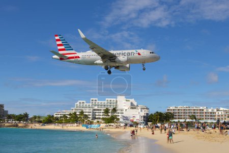 Téléchargez les photos : American Airlines Airbus 320 survolant Maho Beach avant d'atterrir sur l'aéroport international Princess Juliana SXM à Sint Maarten, dans les Caraïbes néerlandaises. - en image libre de droit