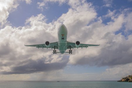 Téléchargez les photos : Grand avion à réaction survolant Maho Beach avant d'atterrir sur l'aéroport international Princess Juliana SXM à Sint Maarten, dans les Caraïbes néerlandaises. - en image libre de droit