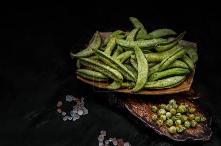 Photo for Healthy roasted sugar snap peas on dark wooden background. Home cooking, Dark tone, Space for text, No focus, specifically. - Royalty Free Image
