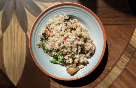 Photo for Homemade Holy Basil and Spicy Herb Fried Rice with Shrimps, Squid and Yardlong Bean. Thai Stir Fried Rice with Seafood and Holy Basil Leaf, Asian food style, Space for text, Top view, Selective focus. - Royalty Free Image