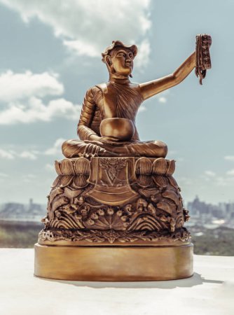 Téléchargez les photos : Bronze figurine of Phra upagupta or Phra bua khem statue with nature background. Selective focus. - en image libre de droit