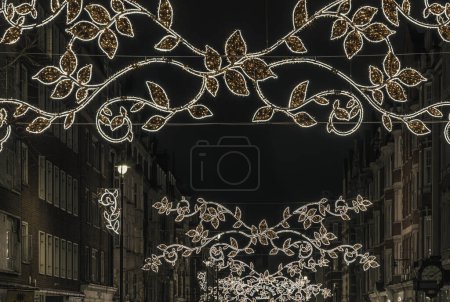 Photo for London, UK - Dec 25, 2023 - Christmas decoration led lights display. Dramatic view of the traditional Christmas decoration lights hanging above Marylebone street during dusk, The Spirit of Christmas, Light Festival in London, Space for text, - Royalty Free Image