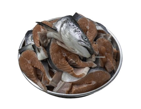 Photo for Metal baking tray filled with Large pieces of fresh raw atlantic salmon and Fresh salmon head isolated on white background with clipping path. The protein is cut into steaks exposing the bright orange color of the fish with grey and black skin. Prepa - Royalty Free Image